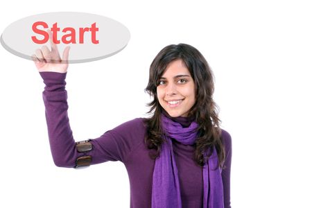 Young girl presses the Start key, isolated in white backgroundの写真素材