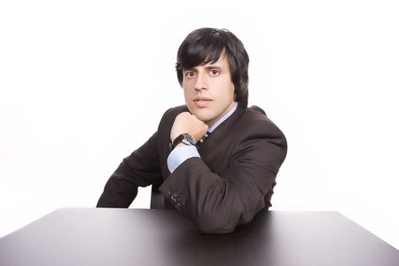 Young Businessman over a desk, full of thoughts, isolated in whiteの写真素材