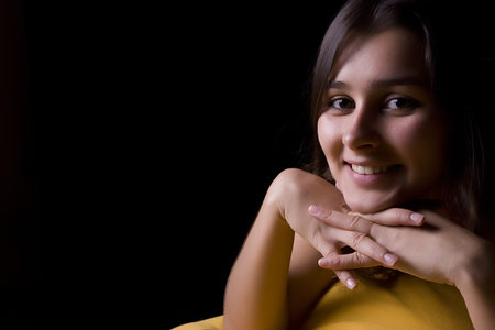 Young beautiful woman portrait, isolated over black background
