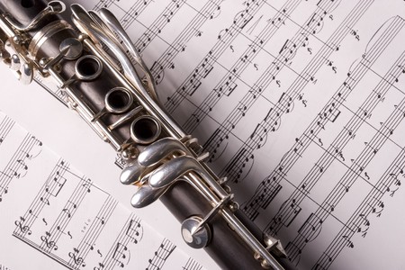 Photograph of a clarinet isolated over sheet musicの写真素材