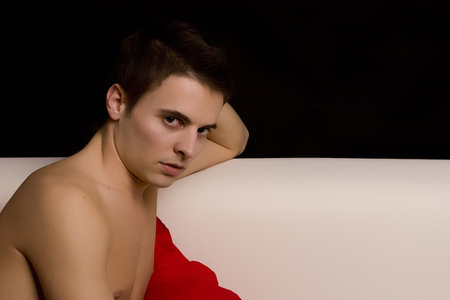 Young casual boy posing isolated over blackの写真素材