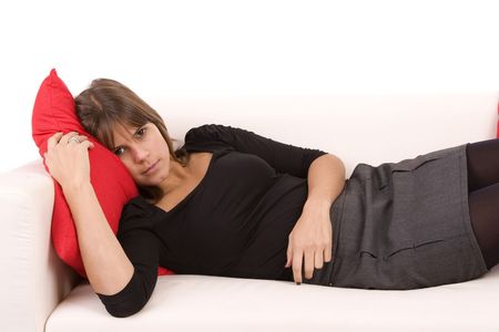 Young woman resting on couch, isolated on whiteの写真素材