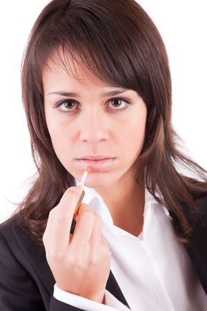 Business woman doing make-up, isolated over whiteの写真素材