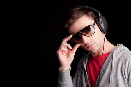 Young man listening to music - isolatedの写真素材