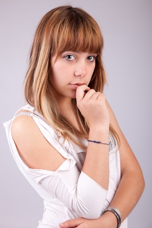 Beautiful woman posing, isolated over grey backgroundの写真素材