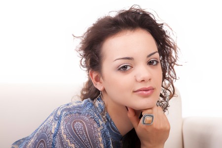Young woman relaxing on couch - isolatedの写真素材