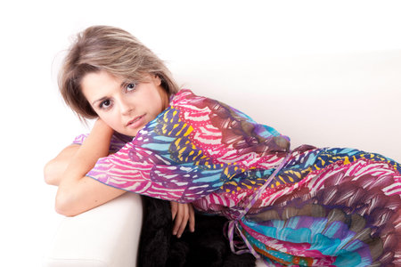 Young woman relaxing on couch, isolated on white