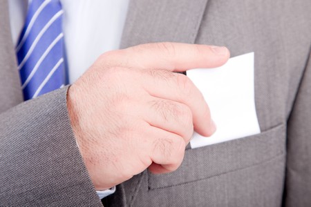 Business man offering card, isolated over white backgroundの写真素材