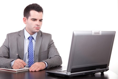 Young business man working with laptop, isolatedの写真素材
