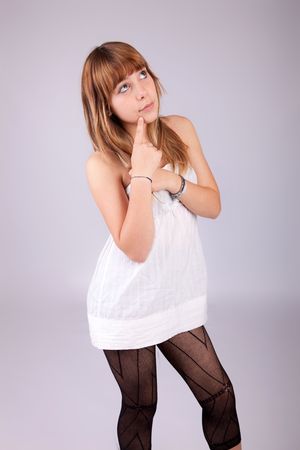 Beautiful woman posing, isolated over grey backgroundの写真素材