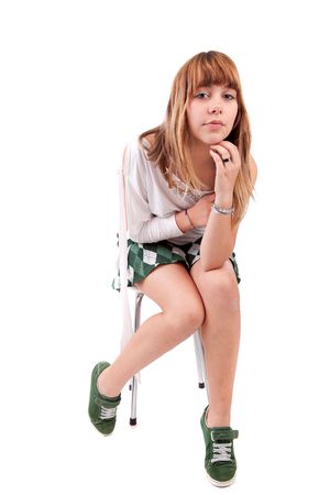 Beautiful woman sitting on a chair, isolatedの写真素材