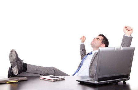 Successful businessman relaxing over desk, isolatedの写真素材