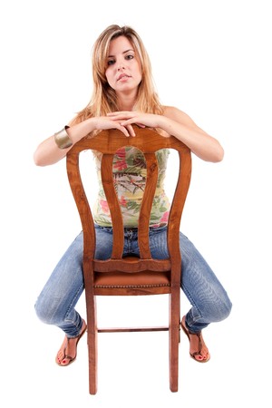 Beautiful woman sitting on a chair, isolatedの写真素材