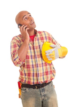 Construction worker at the phone, isolated over whiteの写真素材