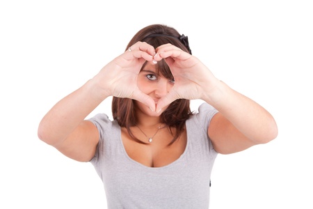 form of heart shaped by the hands of a young womanの写真素材