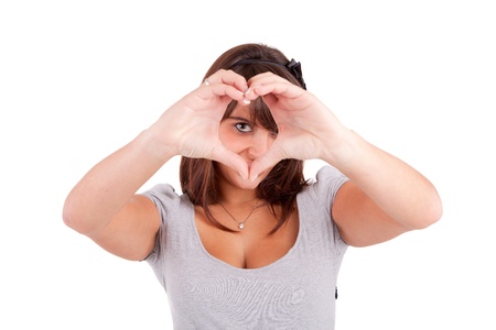 form of heart shaped by the hands of a young womanの写真素材