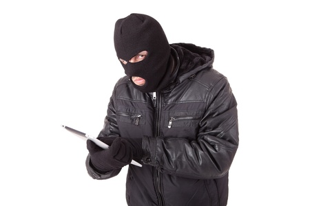Thief holding a laptop, isolated over white backgroundの写真素材