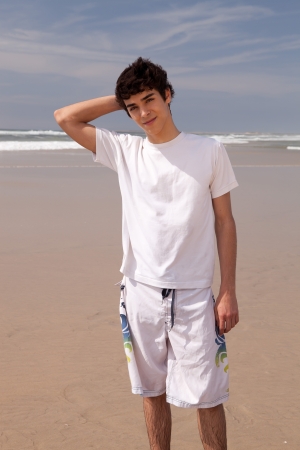 Young handsome man relaxing at the beachの写真素材