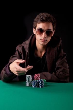 Young handsome man playing texas hold'em pokerの写真素材