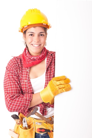 Sexy young woman construction worker, holding a white boardの写真素材