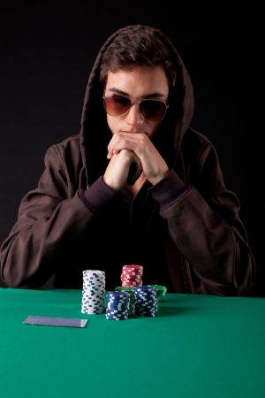 Young handsome man playing texas hold'em pokerの写真素材