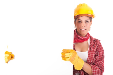 Sexy young woman construction worker, holding a white boardの写真素材