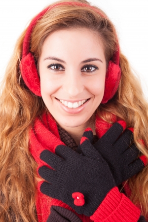 A beautiful young woman dressed for winter, over a white backgroundの写真素材