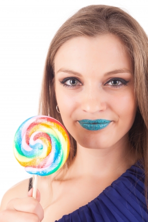 Beautiful woman eating lollipop, over white backgroundの写真素材