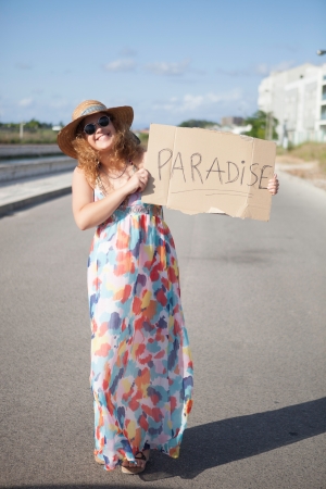Pretty young woman holding a blank cardの写真素材