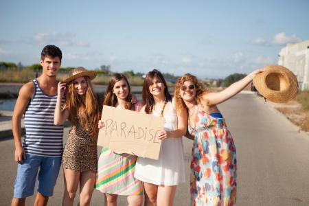 Group of young friends holding a cardの写真素材