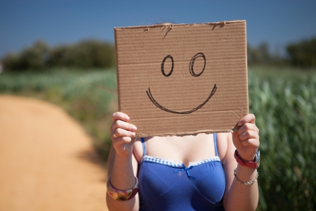Pretty young woman holding a blank cardの写真素材