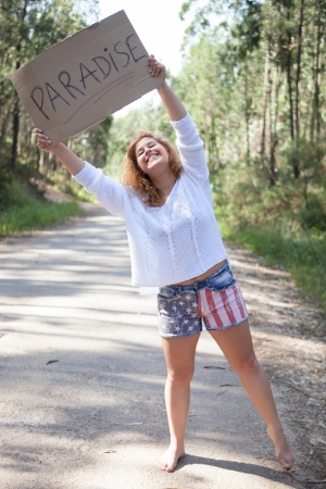 Pretty young woman holding a blank cardの写真素材
