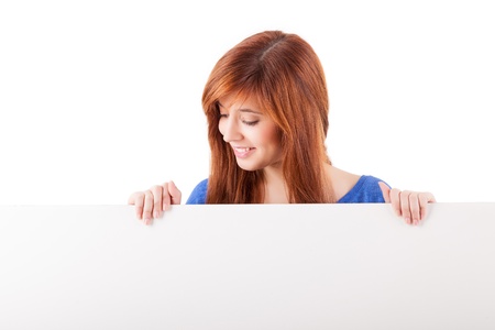 Beautiful Redhead Woman Holding White Sign の写真素材