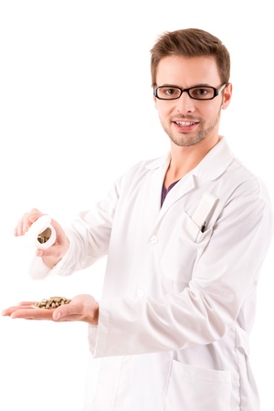 A young doctor holding some pills, isolated over whiteの写真素材