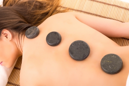 A young beautiful woman relaxing at a spa (wellness concept)の写真素材