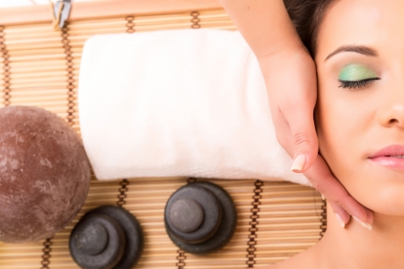 A young beautiful woman relaxing at a spa (wellness concept)の写真素材