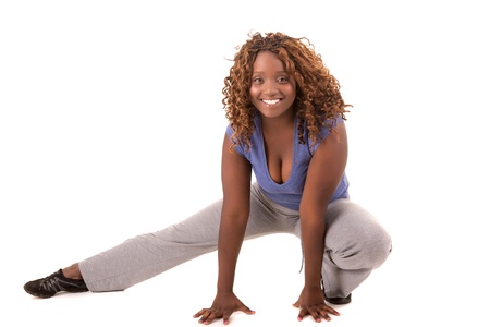 Beautiful large african woman doing exercise - Isolated over whiteの写真素材