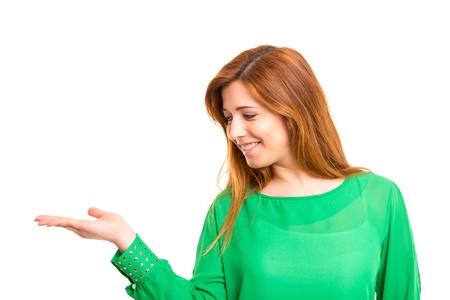 Young beautiful woman presenting your product, isolated over white backgroundの写真素材