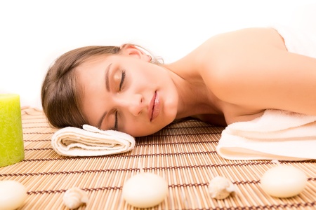 A young beautiful woman relaxing at a spa (wellness concept)の写真素材
