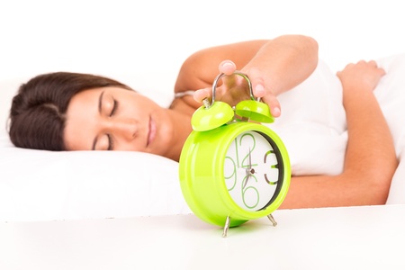 Woman waking up with the sound of the alarm clockの写真素材