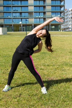 A beautiful young woman making some exercise at the park - fitness conceptの写真素材