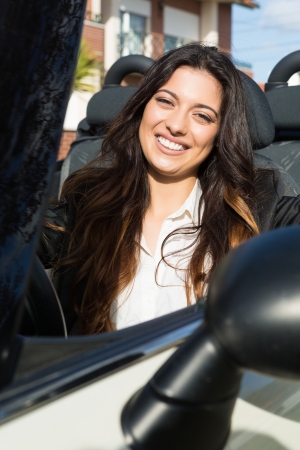 A young successful business woman in a luxurious convertible sports carの写真素材