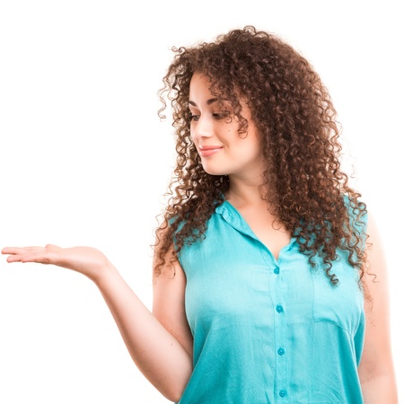 Young beautiful woman presenting your product, isolated over white backgroundの写真素材