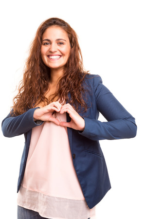 Beautiful woman making a heart shape with her hands, isolated over white backgroundの写真素材
