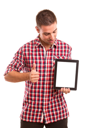 Happy young man presenting your product in a tablet computerの写真素材