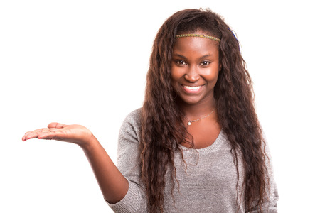 Young beautiful woman presenting your product, isolated over white backgroundの写真素材