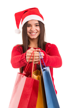 A beautiful asian woman with santa claus hat offering giftsの写真素材