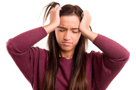 Young asian woman with headache, isolated over whiteの写真素材