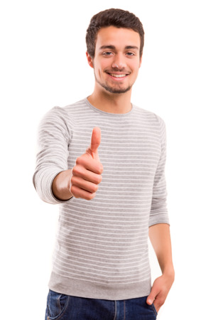 Handsome young man signaling ok, isolated over a white backgroundの写真素材