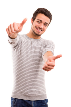 Handsome young man signaling ok, isolated over a white backgroundの写真素材
